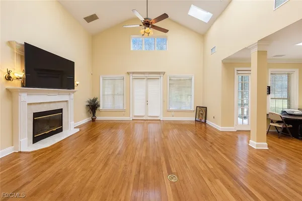 a view of a livingroom with wooden floor and a fireplace