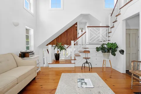 a view of entryway and hall with wooden floor