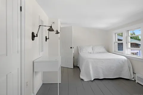 a bedroom with a bed and a table