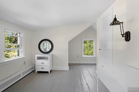 a view of room with window and wooden floor