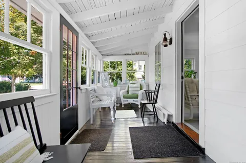 a dining room with wooden floor and a rug