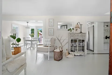 a living room with furniture a table and gym equipment