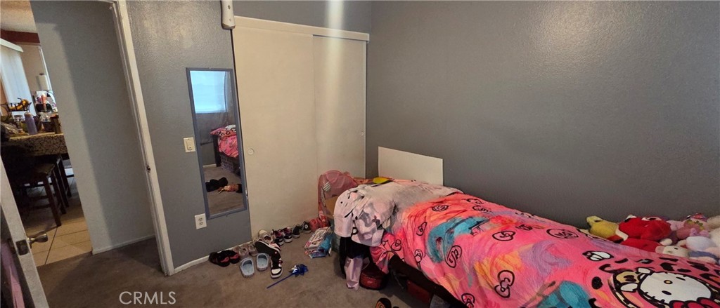 1548 Ranch Road San Bernardino, CA 92407 - Photo 12 of 26 a bedroom with a bed and a dresser