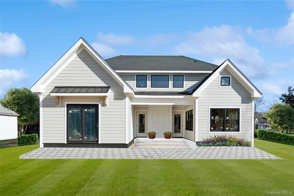 a front view of a house with a yard and porch