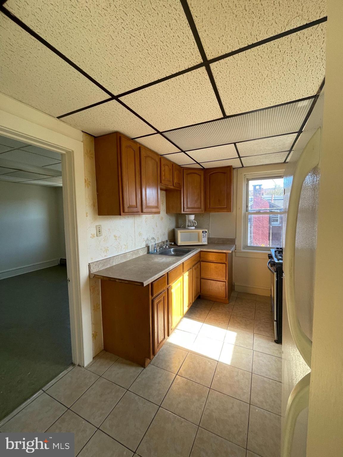 1139 Church Street, Unit D Reading, PA 19601 - Photo 3 of 6 a kitchen with stainless steel appliances granite countertop a sink and cabinets