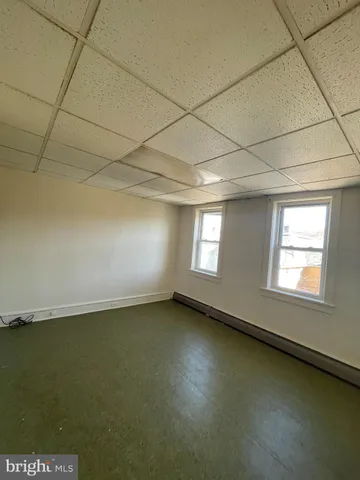 an empty room with a empty space and windows