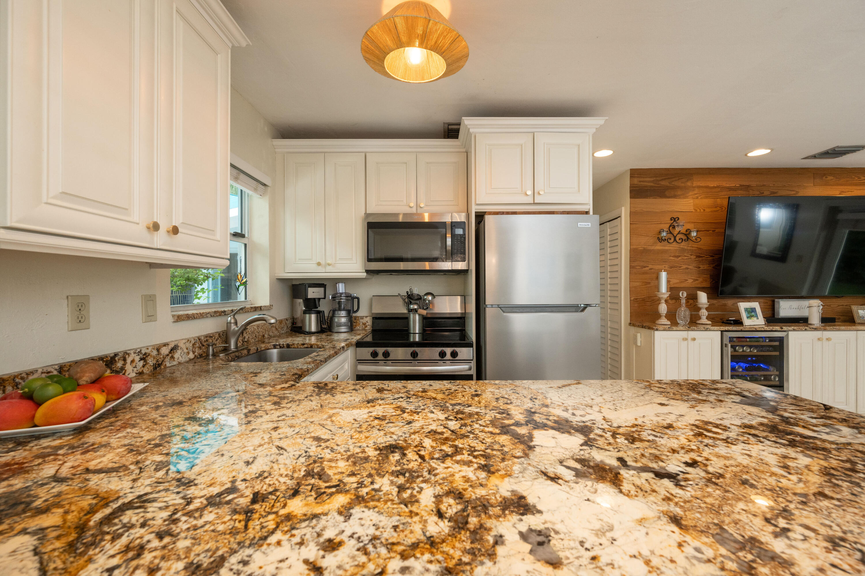 1523 Seminary Street Key West, FL 33040 - Photo 10 of 38 a kitchen with granite countertop a refrigerator and a stove top oven