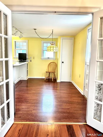 a view of a living room with furniture and floor to ceiling window