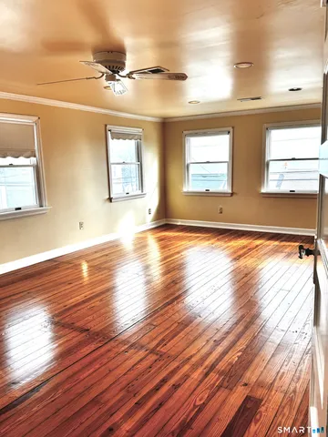 a view of a room with wooden floor