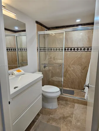 a bathroom with a sink toilet and shower