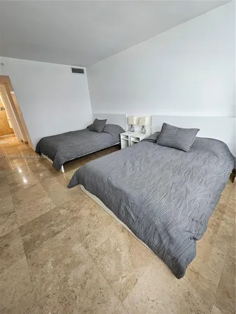 a bedroom with two beds and painted walls