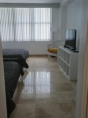 a view of a livingroom with furniture and staircase