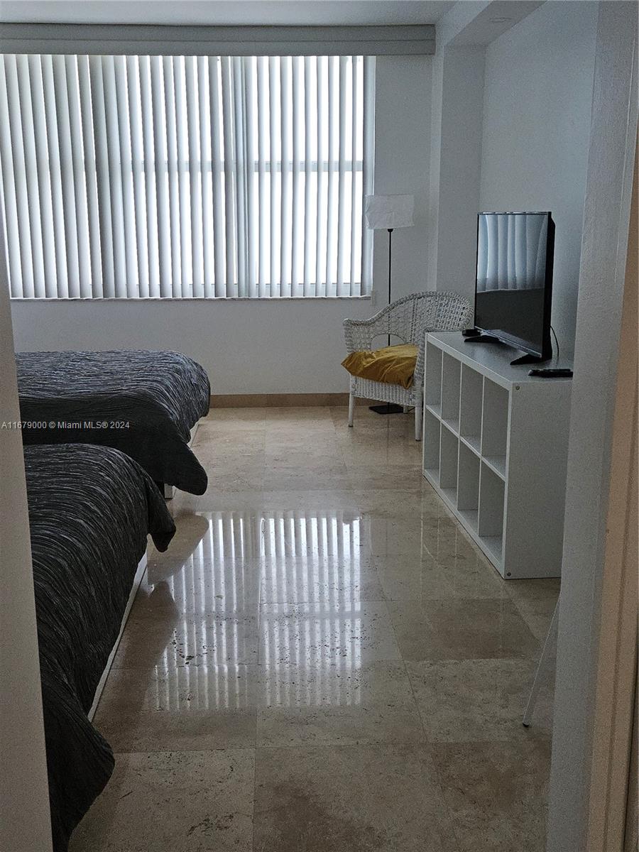 5601 Collins Avenue, Unit 1605 Miami Beach, FL 33140 - Photo 15 of 19 a view of a livingroom with furniture and staircase
