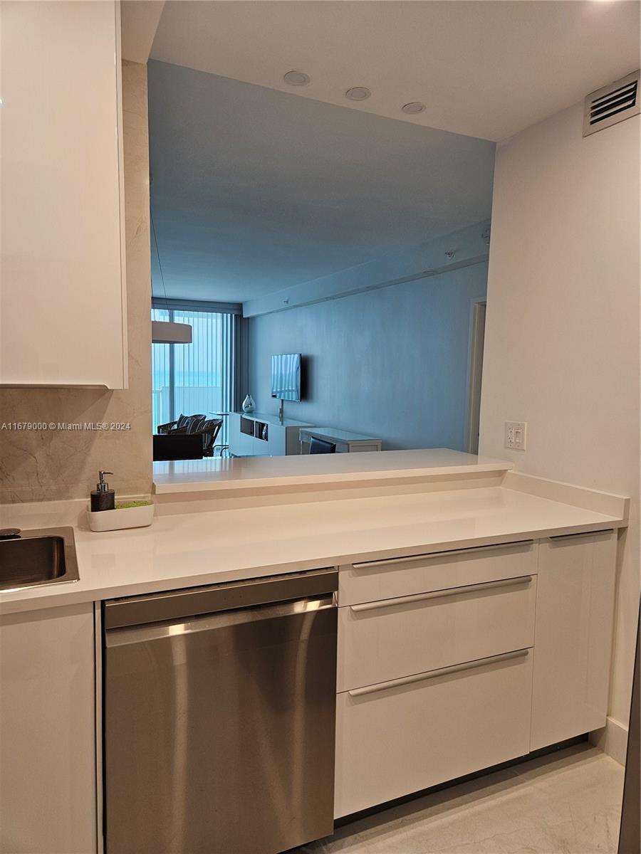 5601 Collins Avenue, Unit 1605 Miami Beach, FL 33140 - Photo 6 of 19 a room with storage and utility