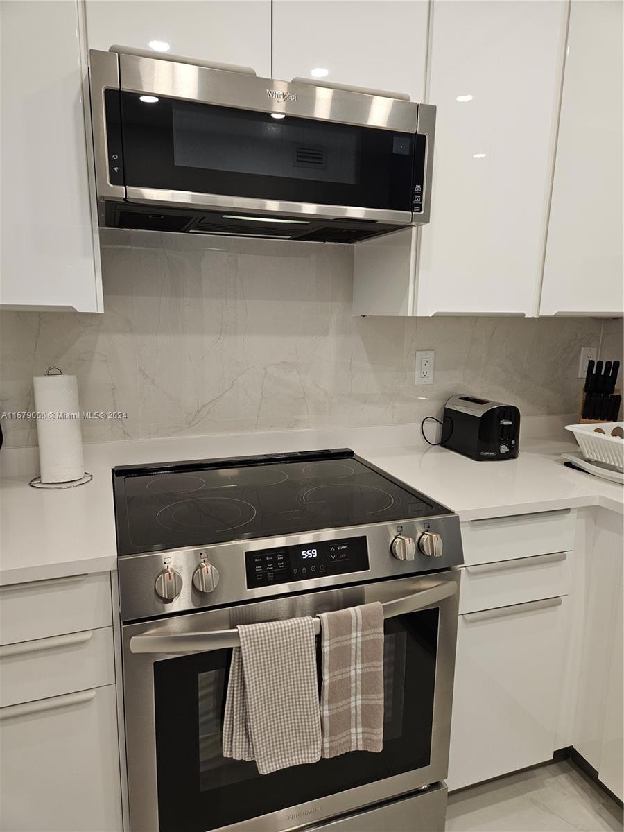 5601 Collins Avenue, Unit 1605 Miami Beach, FL 33140 - Photo 7 of 19 a stove top oven sitting inside of a kitchen