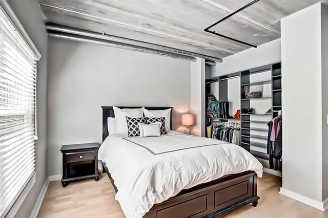 a bedroom with a bed and a window