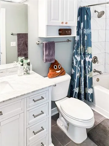 a bathroom with a sink a toilet and shower curtain