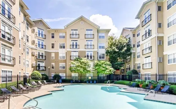 a view of a building with garden and trees