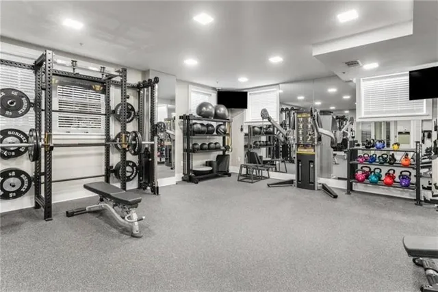 a media room with lots of chairs and a large window