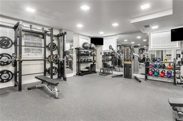 a media room with lots of chairs and a large window