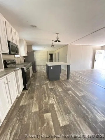 a view of a kitchen with furniture and windows