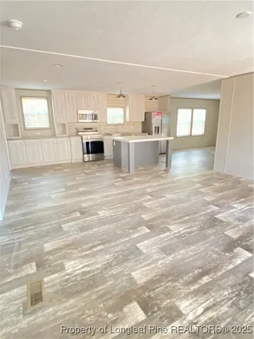 en empty room with windows and closet