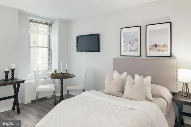 a bedroom with a bed and a table