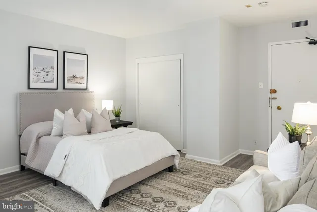 a bedroom with a bed and a couch