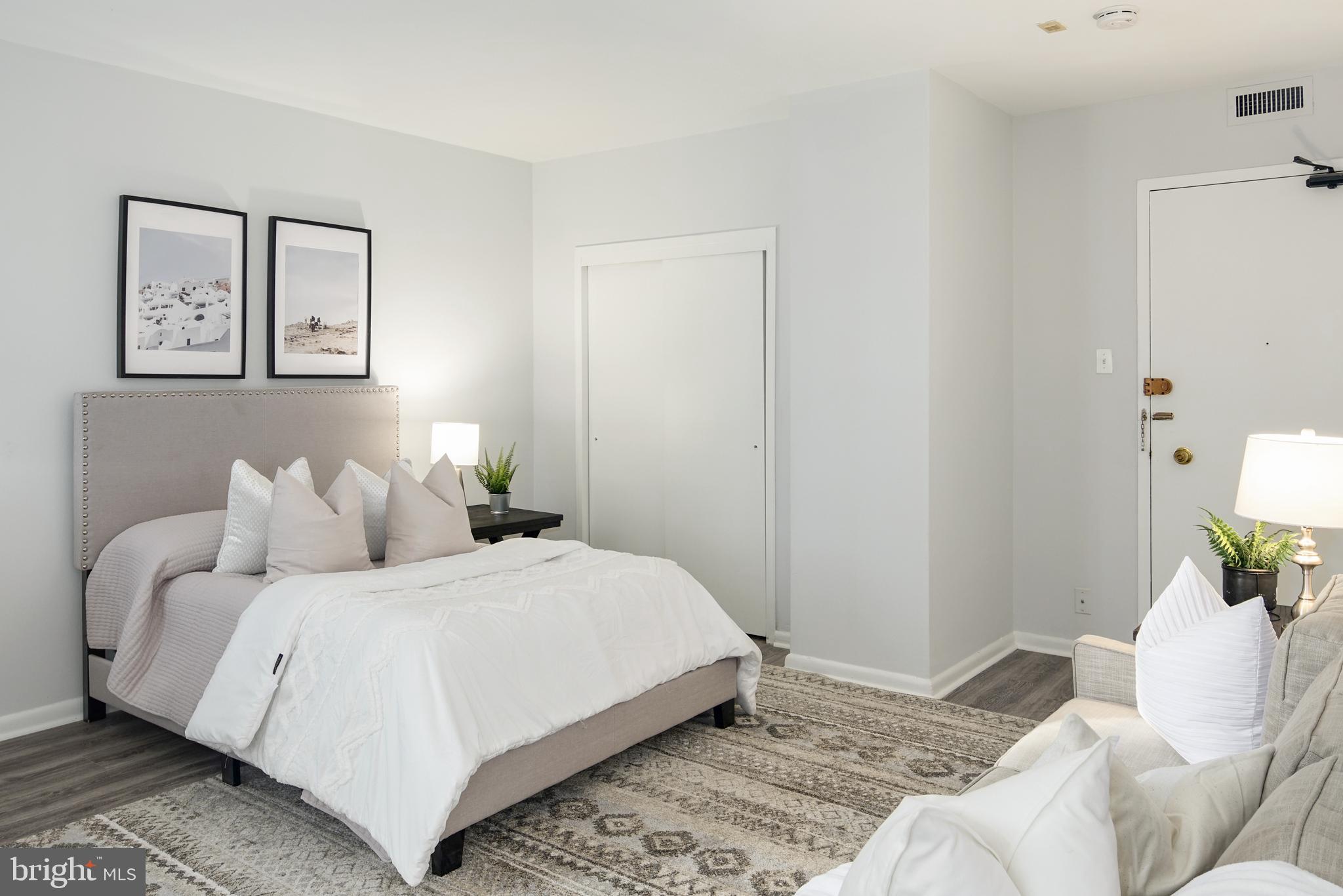 135 South 19th Street, Unit 913 Philadelphia, PA 19103 - Photo 4 of 15 a bedroom with a bed and a couch