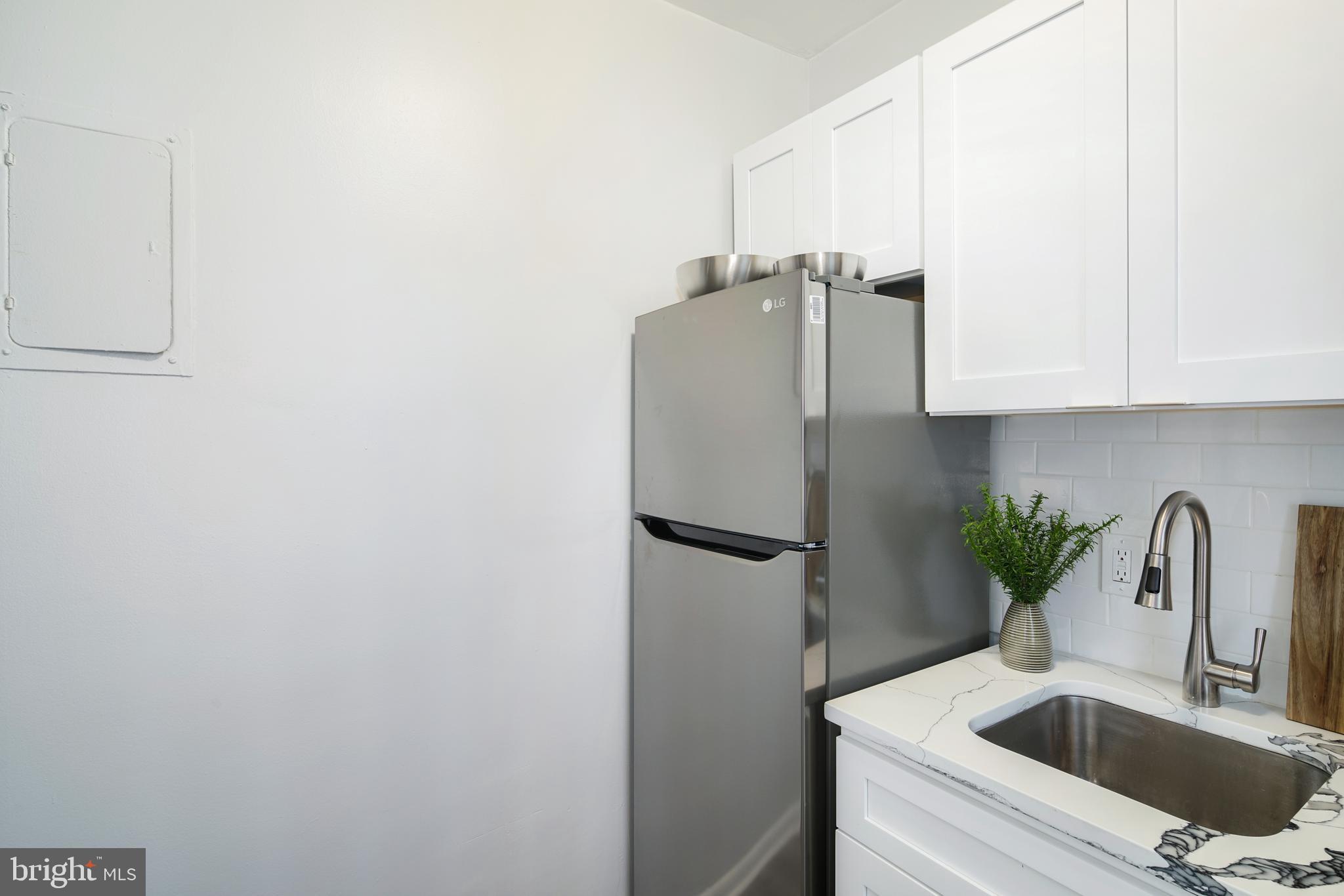 135 South 19th Street, Unit 913 Philadelphia, PA 19103 - Photo 8 of 15 a kitchen with refrigerator and cabinets