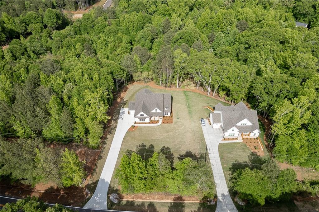 1210 Austin Road Winder, GA 30680 - Photo 54 of 56 an aerial view of a house with a yard and large trees