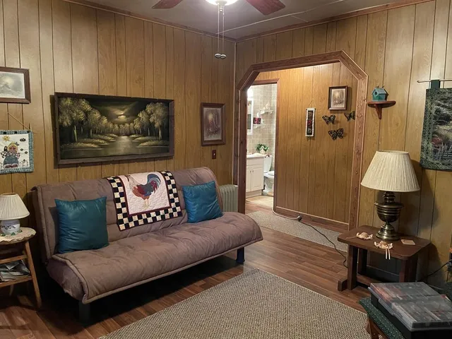 a living room with furniture and a lamp