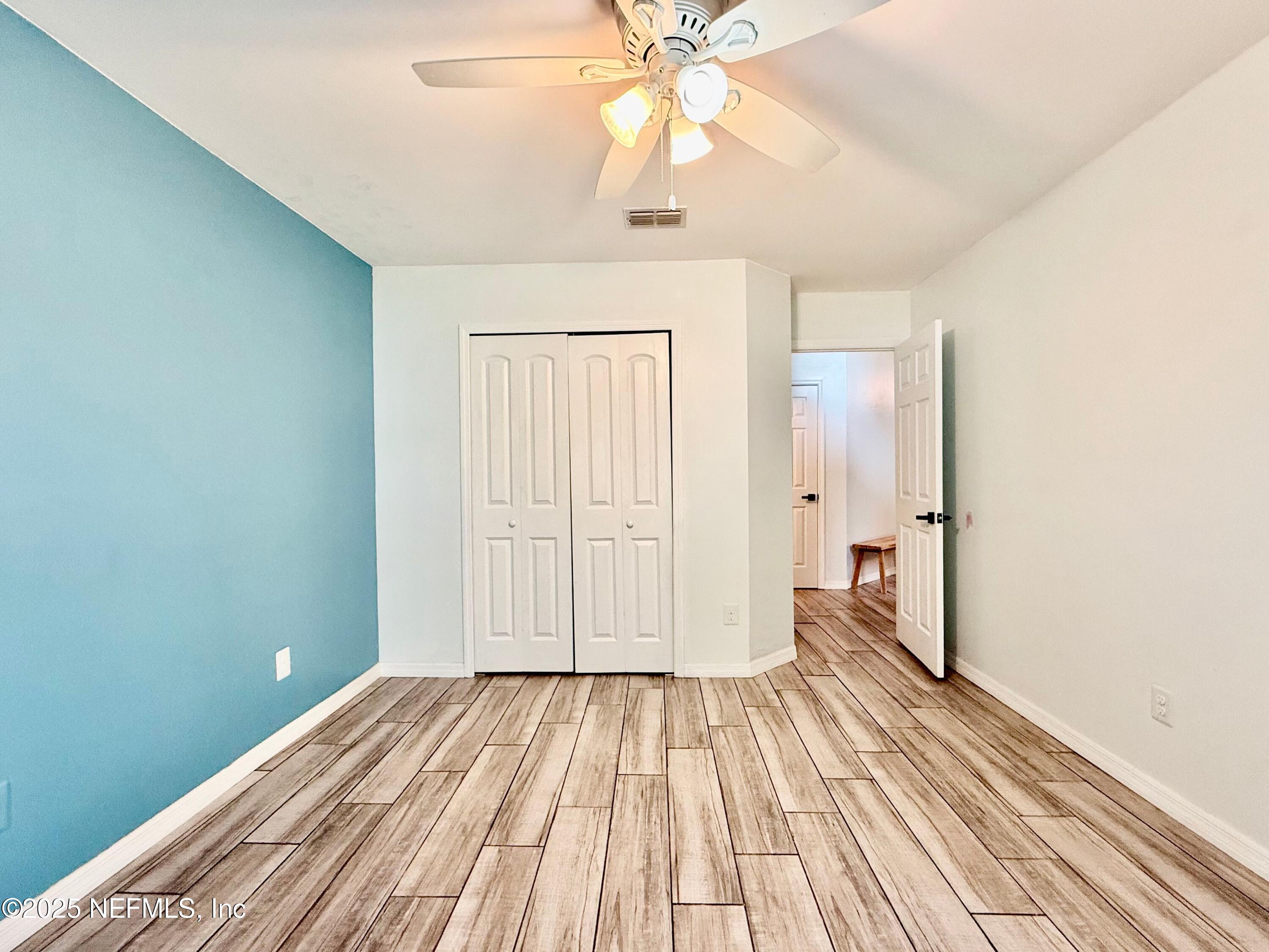 168 Patrick Mill Circle Ponte Vedra Beach, FL 32082 - Photo 21 of 33 a view of a room with wooden floor closet and a ceiling fan