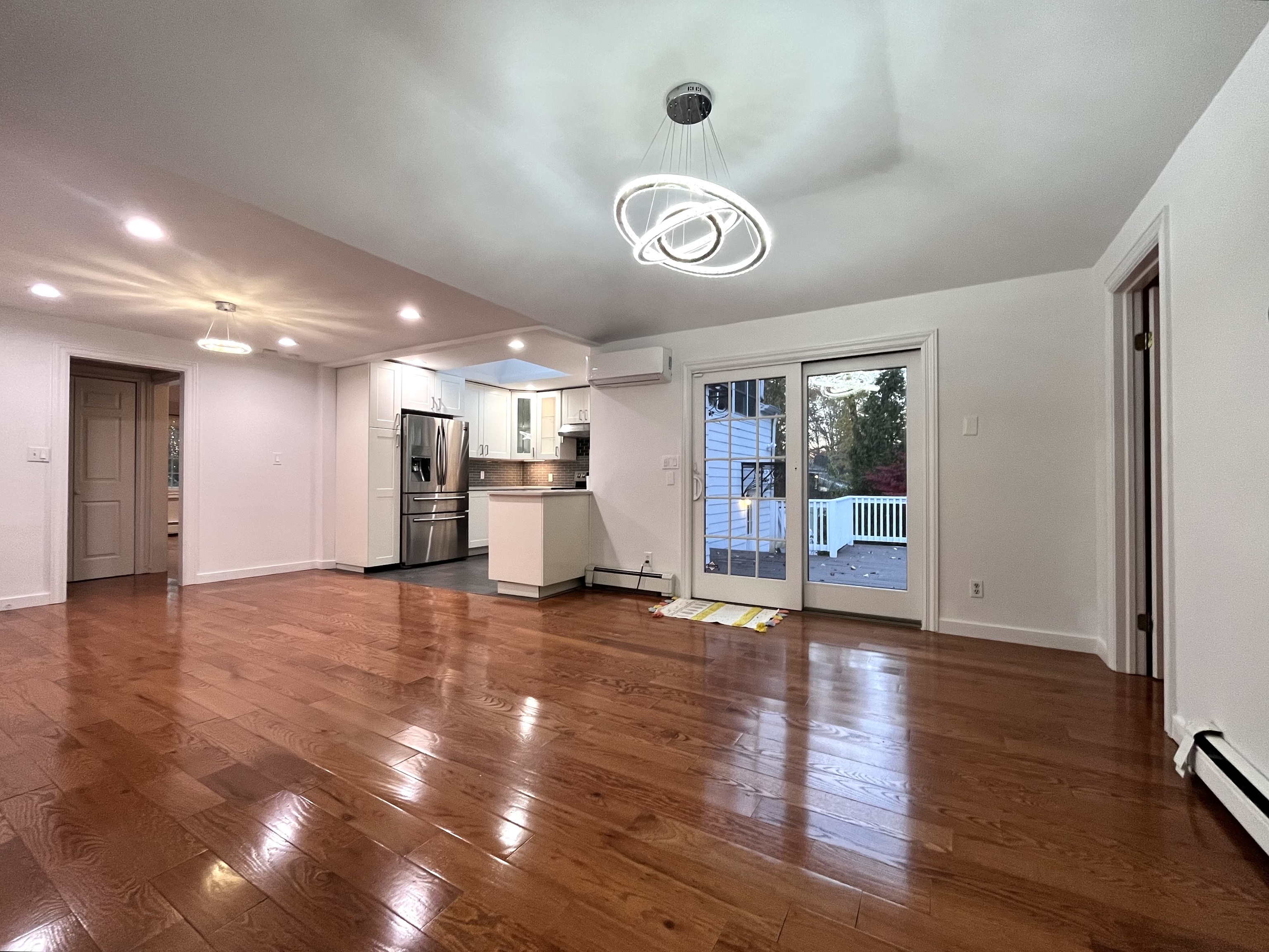 158 Jelliff Mill Road New Canaan, CT 06840 - Photo 11 of 40 an empty room with wooden floor and a large window