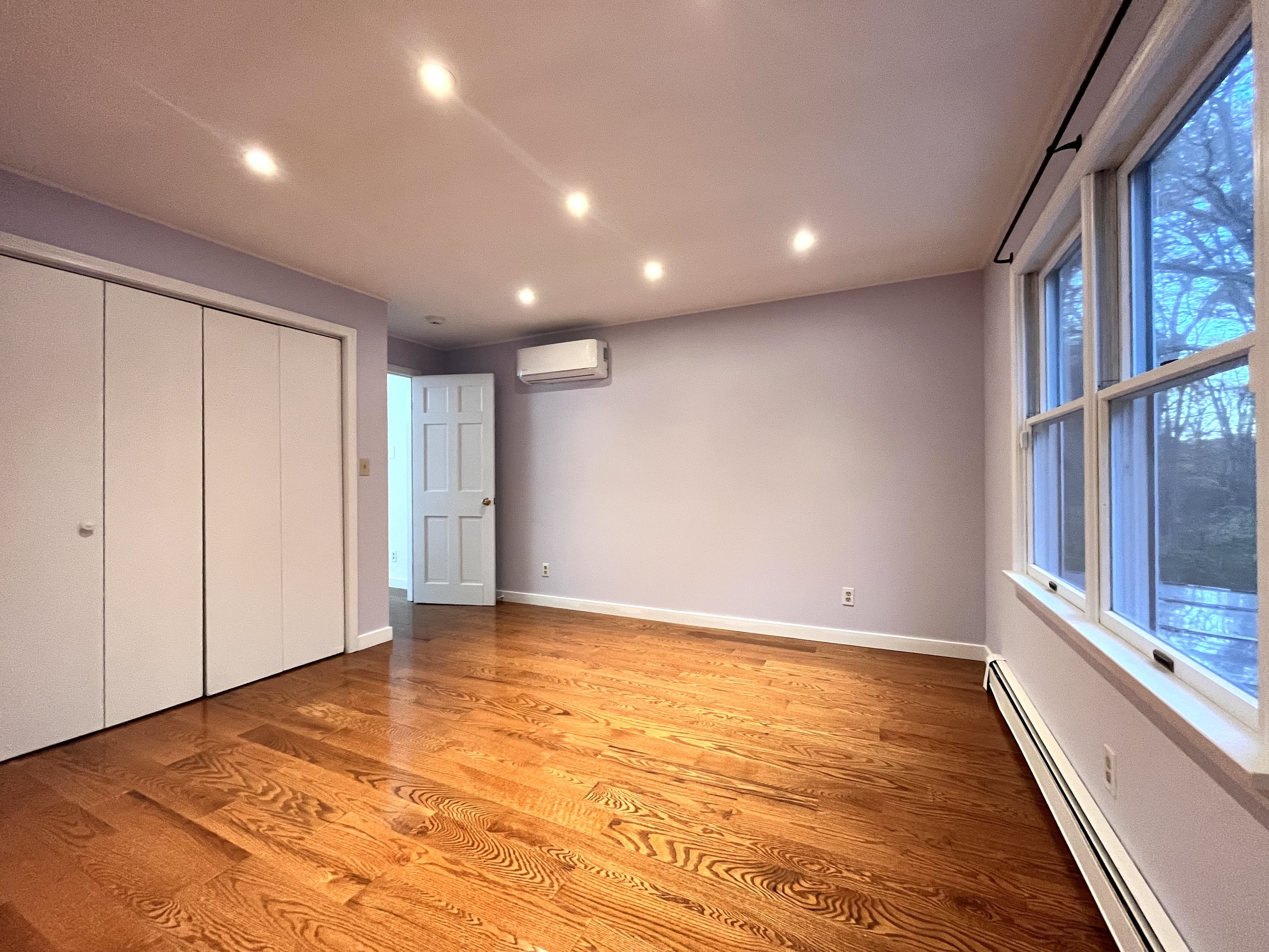 158 Jelliff Mill Road New Canaan, CT 06840 - Photo 14 of 40 a view of an empty room with wooden floor and a window