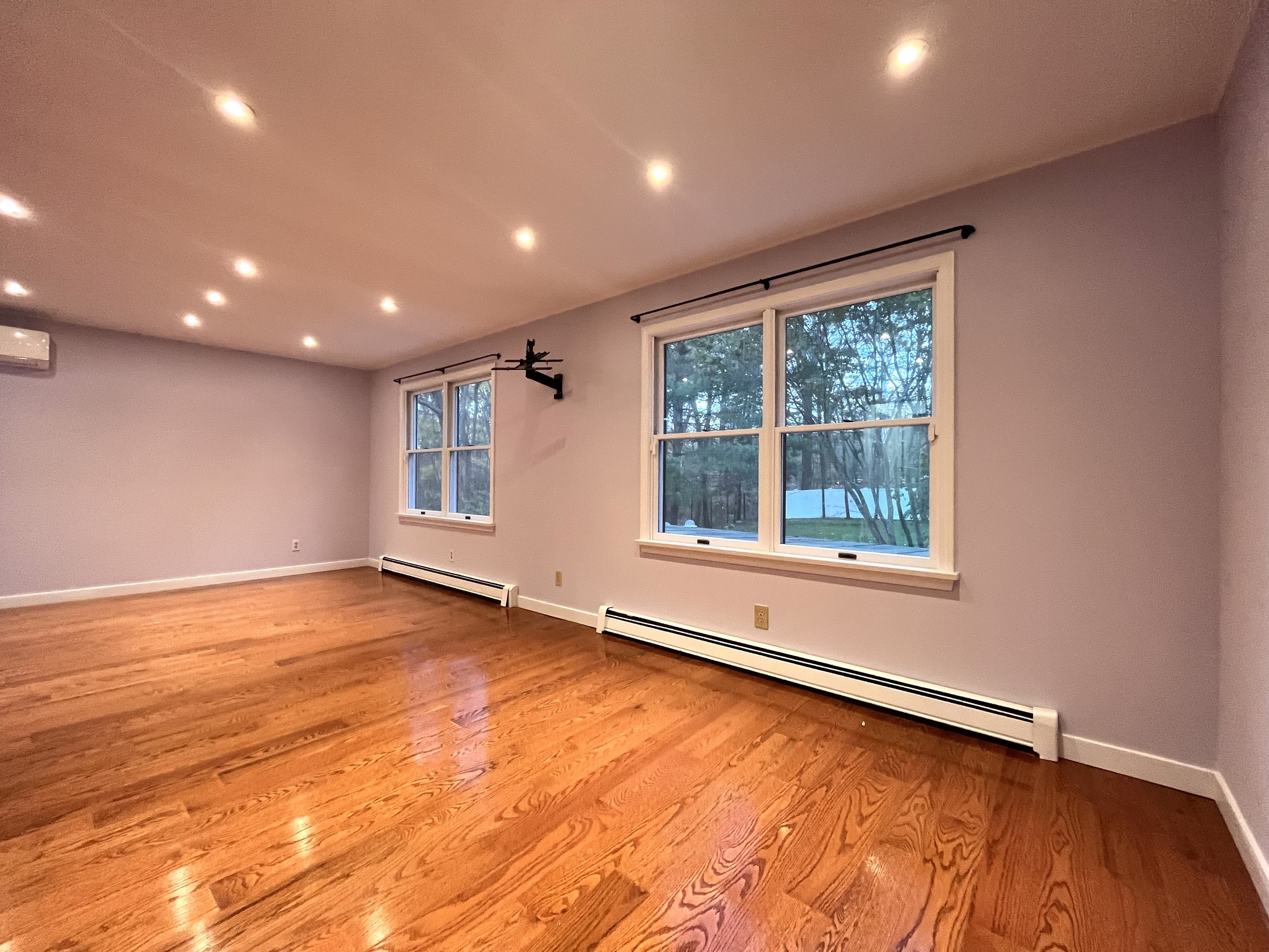 158 Jelliff Mill Road New Canaan, CT 06840 - Photo 16 of 40 a view of an empty room with wooden floor and a window