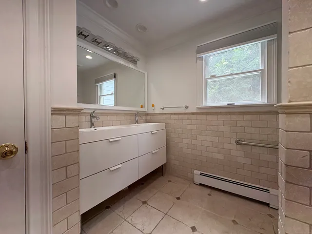 a bathroom with a toilet sink and shower
