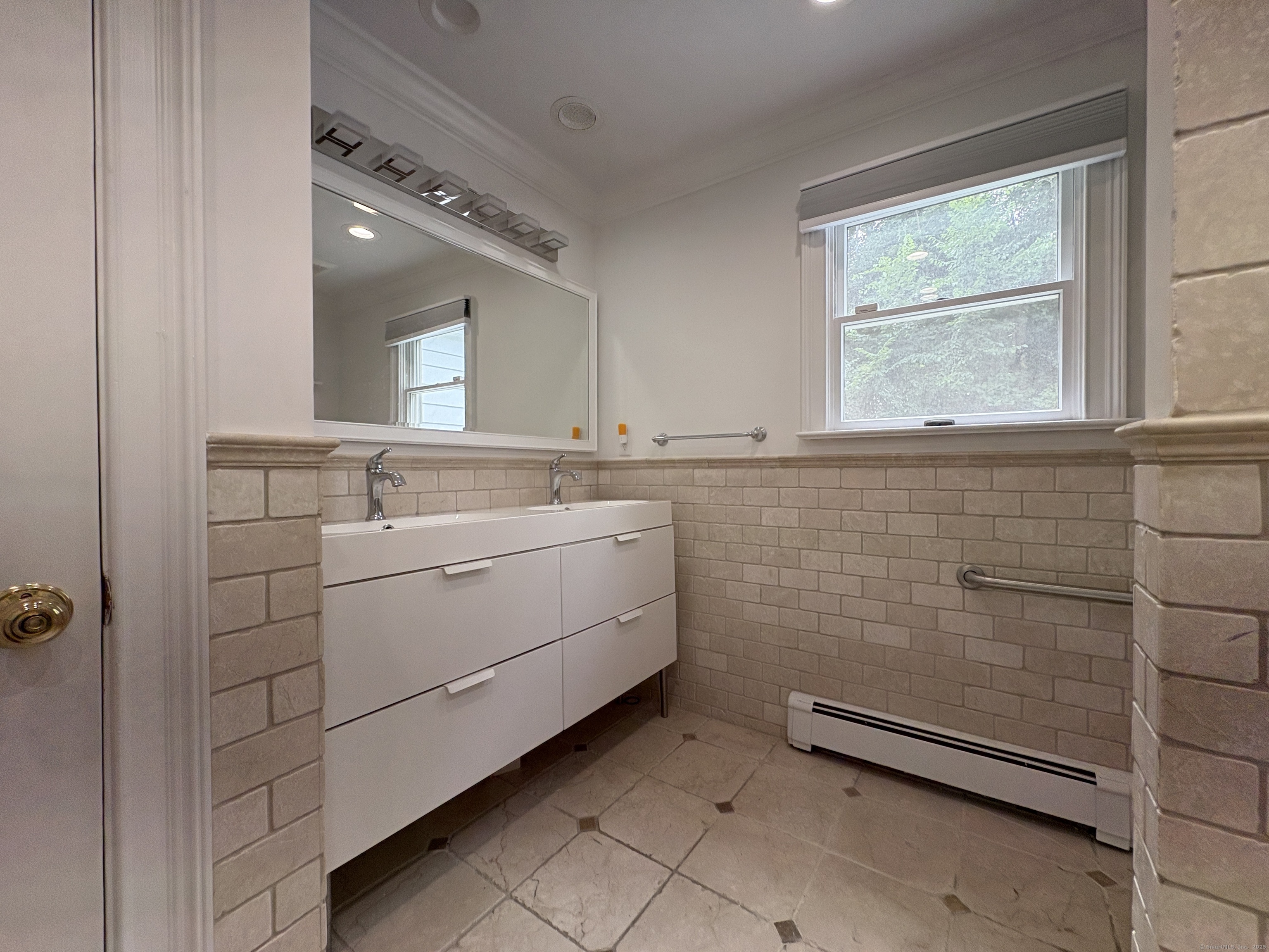 158 Jelliff Mill Road New Canaan, CT 06840 - Photo 17 of 40 a bathroom with a sink a vanity and a mirror
