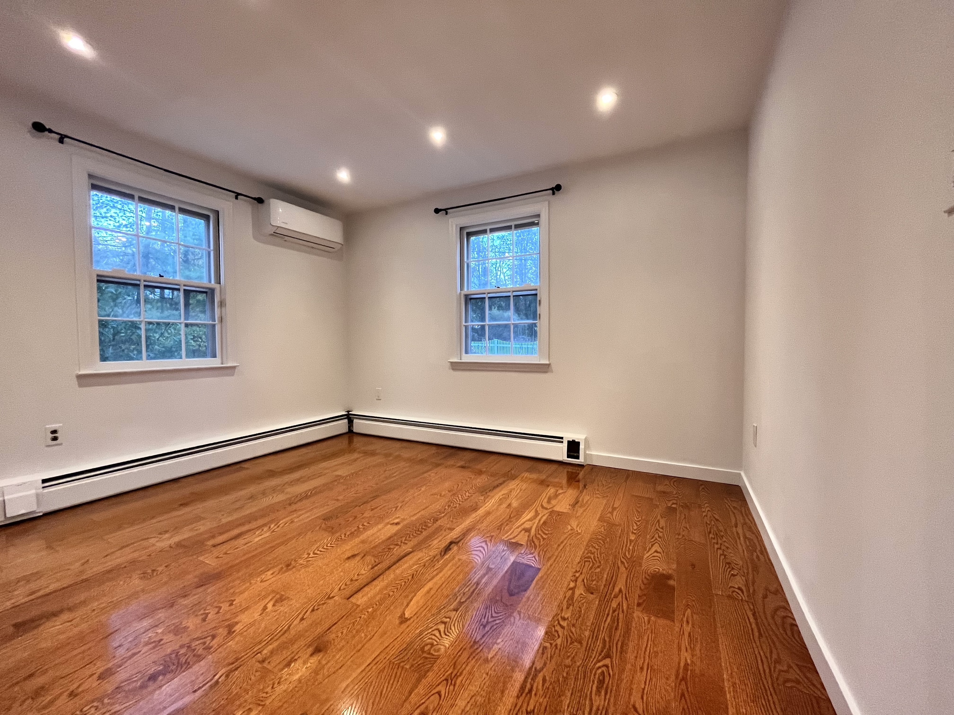158 Jelliff Mill Road New Canaan, CT 06840 - Photo 20 of 40 a view of an empty room with wooden floor and a window