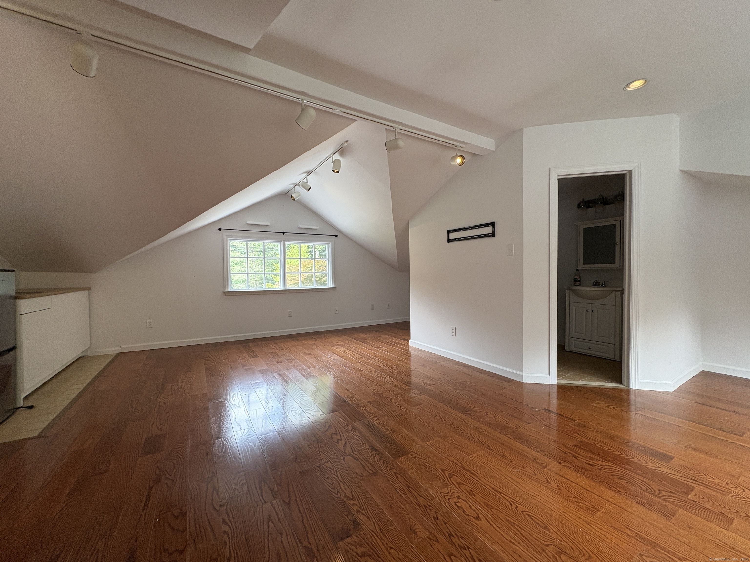 158 Jelliff Mill Road New Canaan, CT 06840 - Photo 24 of 40 an empty room with wooden floor cabinet and windows
