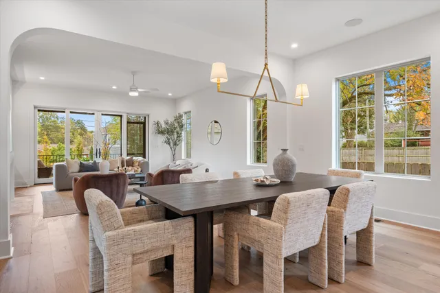 a view of a a dining room with furniture window and wooden floor