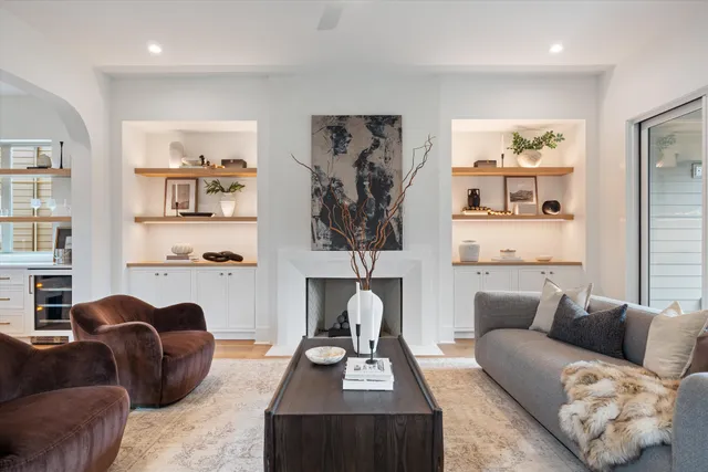 a living room with furniture fireplace and window