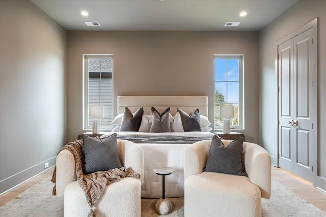 a spacious bedroom with bed and window