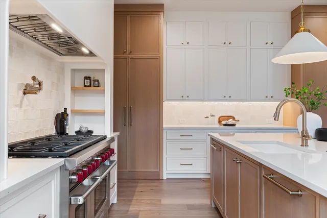 a kitchen that has a sink and a stove