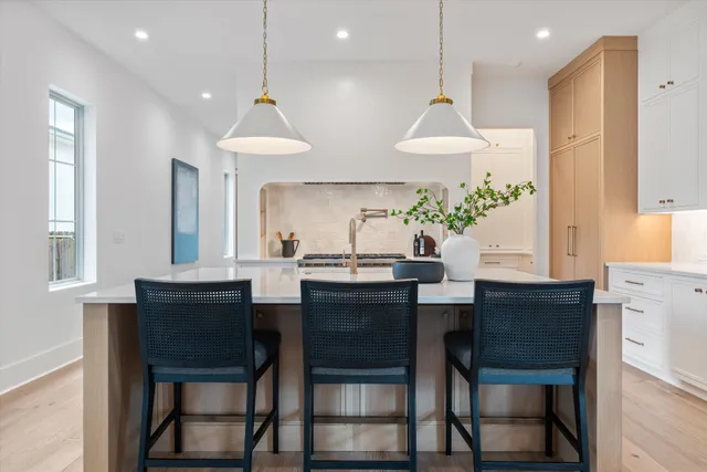 a dining room with wooden table and chairs