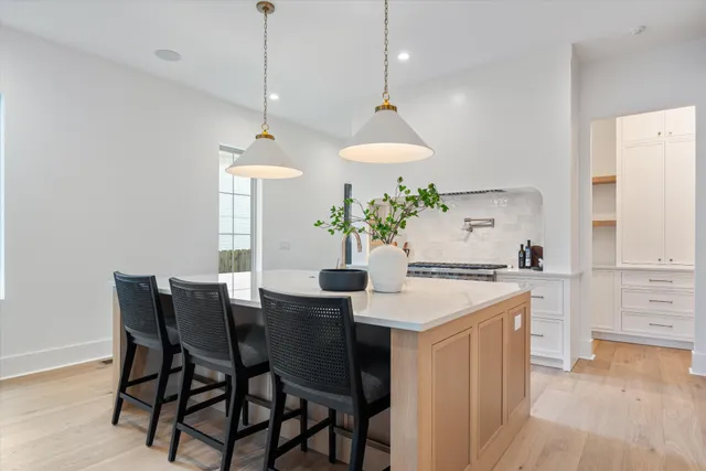 a kitchen that has a table and chairs in it