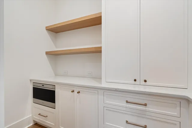 a kitchen with kitchen island a island a sink a counter space and wooden floor