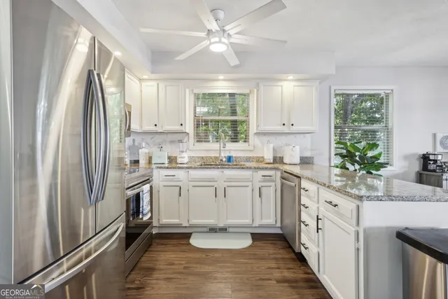 a kitchen with a sink stove and refrigerator