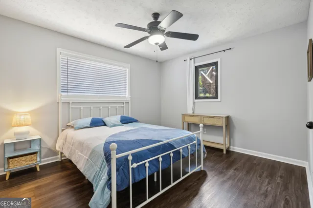 a bedroom with a bed next to a window