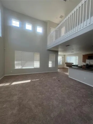 a view of a hallway with entryway and kitchen